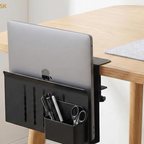 Black holder with a laptop clamped to the edge of a wooden desk